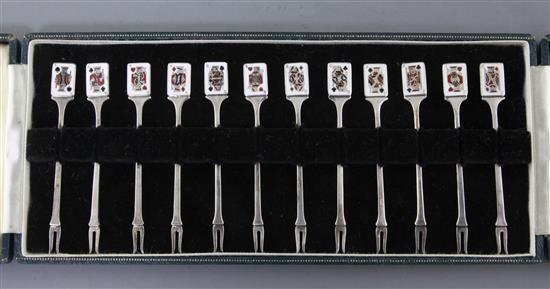 A cased set of twelve Garrard & Co Ltd silver and enamel cocktail forks 87mm.